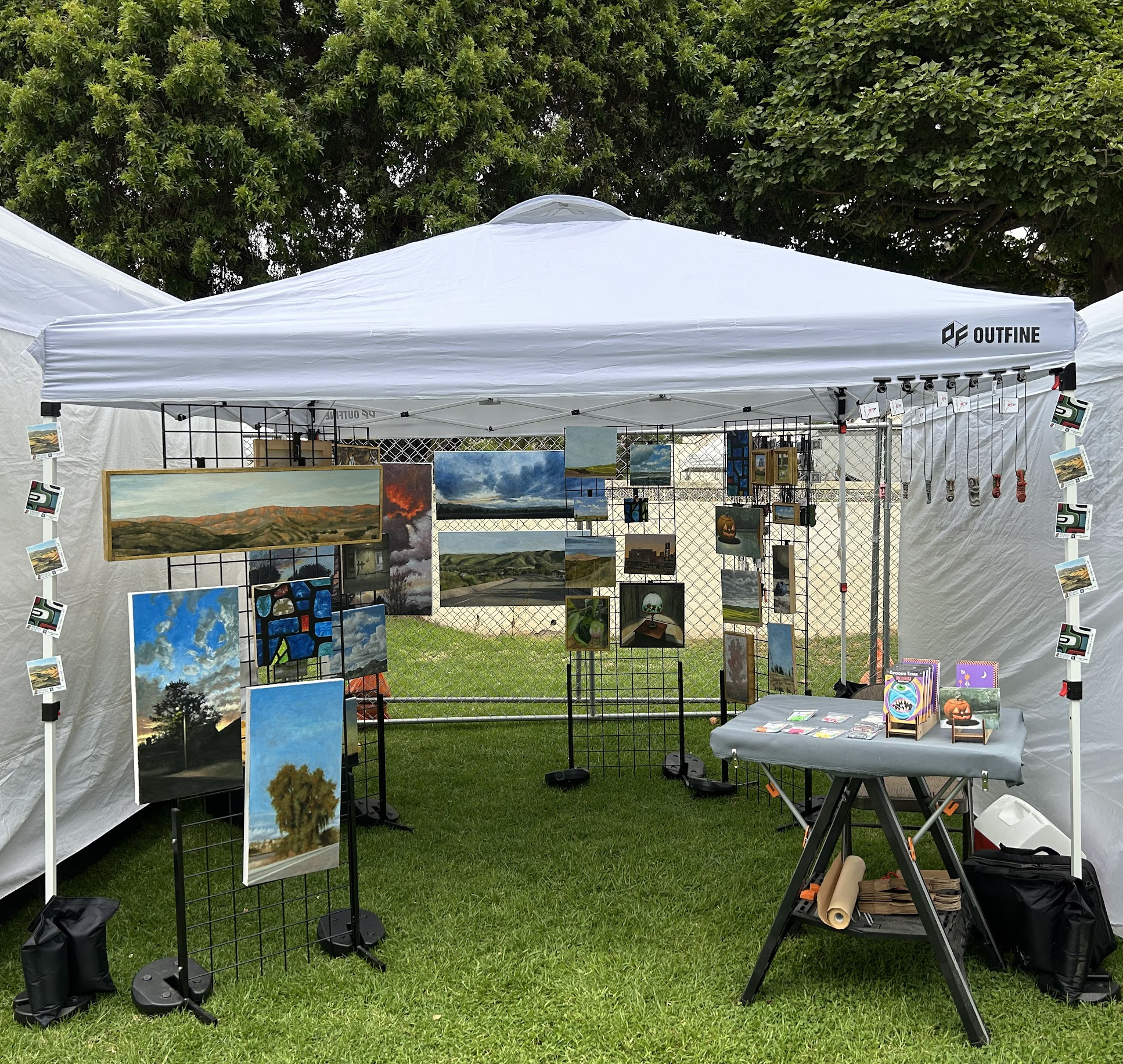 a 10 by 10 foot pop up tent filled with various sized oil paintings, mostly of areas around Ventura County, Moorpark in particular.